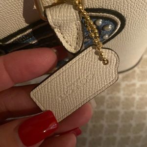 White coach purse with butterfly